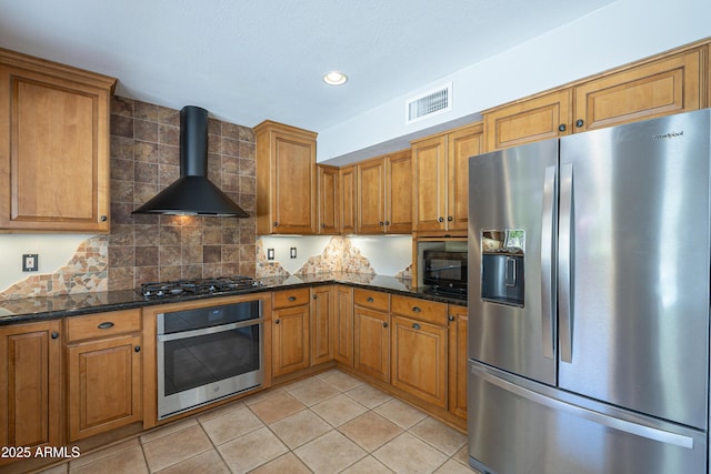 2340 W Myrtle Dr, Chandler, AZ 85248 - kitchen featuring appliances with stainless steel finishes, wall chimney range hood, brown cabinets, tasteful backsplash, and recessed lighting