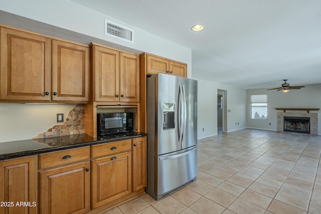 2340 W Myrtle Dr, Chandler, AZ 85248 - kitchen featuring stainless steel refrigerator with ice dispenser, black microwave, light tile patterned flooring, brown cabinetry, and recessed lighting