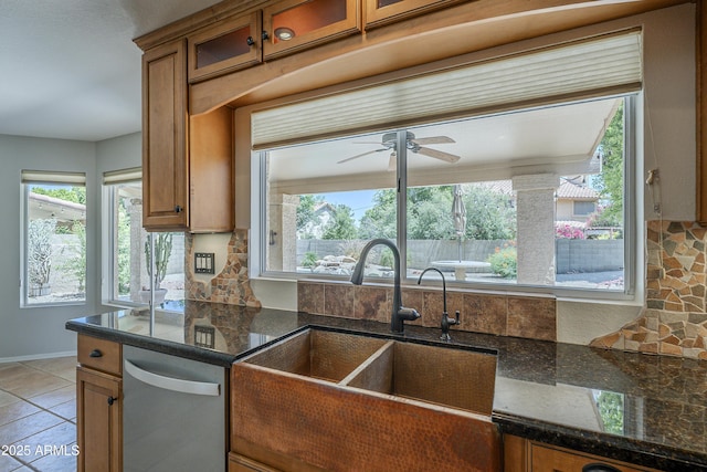 2340 W Myrtle Dr, Chandler, AZ 85248 - kitchen featuring stainless steel dishwasher, brown cabinets, tasteful backsplash, a ceiling fan, and dark stone countertops