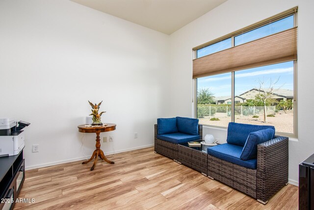 sitting room with light wood-style floors and baseboards