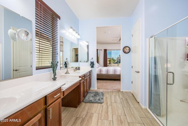 ensuite bathroom with ceiling fan, a stall shower, ensuite bath, and vanity