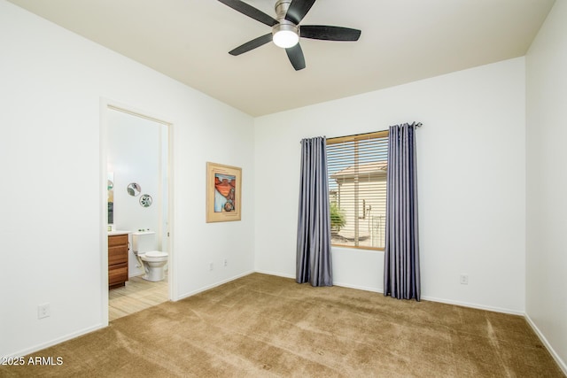 unfurnished bedroom featuring baseboards, connected bathroom, and light colored carpet