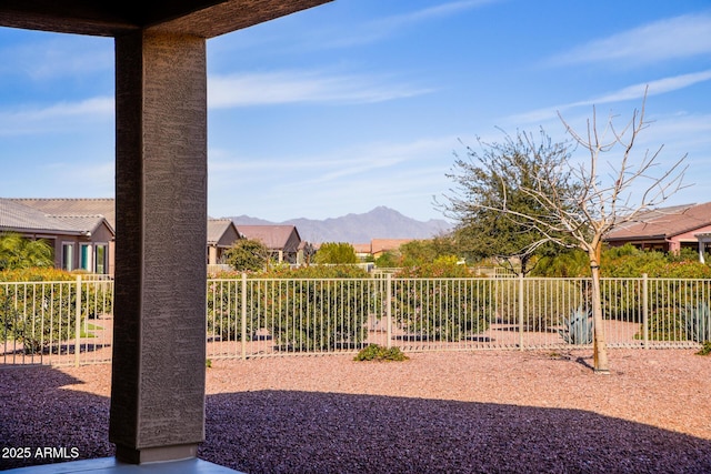 view of yard with fence and a mountain view