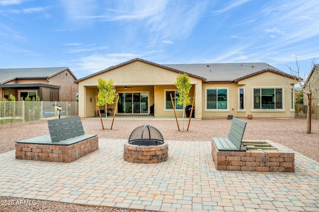 back of house with a fire pit, a patio, a tiled roof, fence, and stucco siding