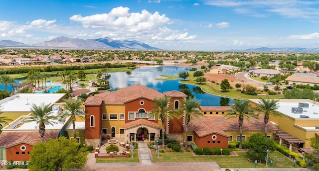 drone / aerial view featuring a residential view and a water and mountain view