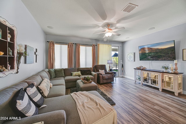 living room with hardwood / wood-style floors and ceiling fan