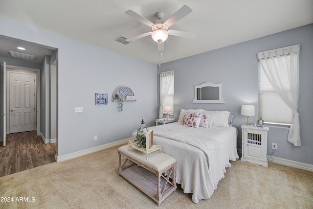 bedroom with ceiling fan and light carpet