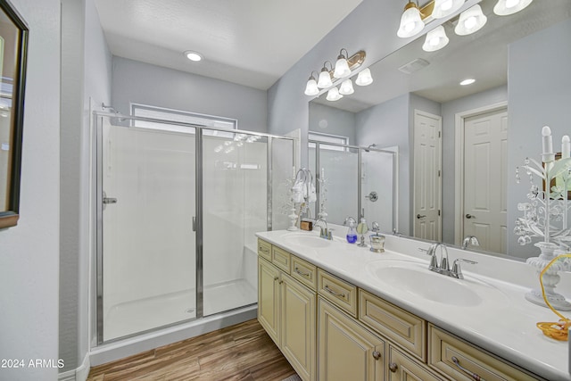 bathroom with vanity, an enclosed shower, and wood-type flooring