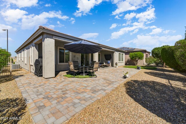 rear view of property featuring a patio