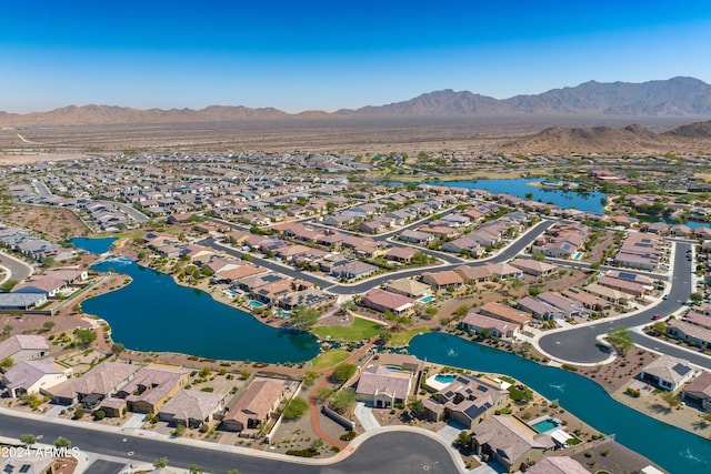 drone / aerial view featuring a water and mountain view