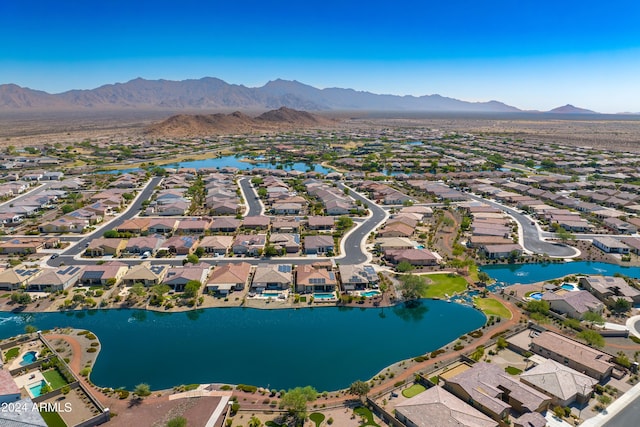 birds eye view of property with a water and mountain view