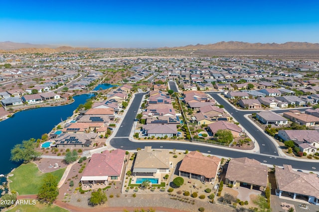 birds eye view of property with a water and mountain view