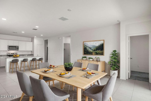 dining area featuring light tile patterned flooring, recessed lighting, and visible vents