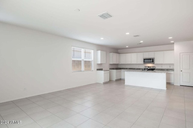 kitchen with visible vents, open floor plan, recessed lighting, white cabinetry, and stainless steel appliances