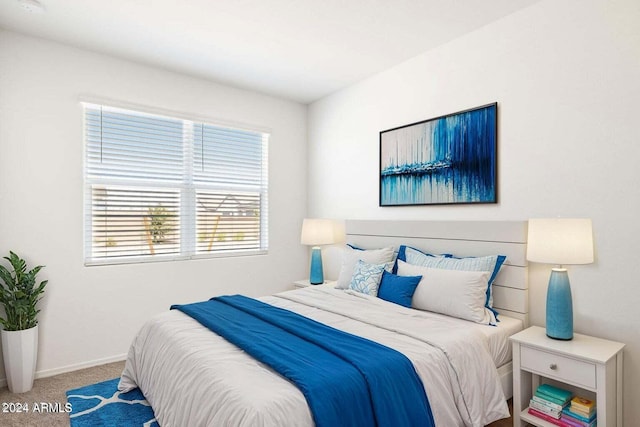 carpeted bedroom with baseboards