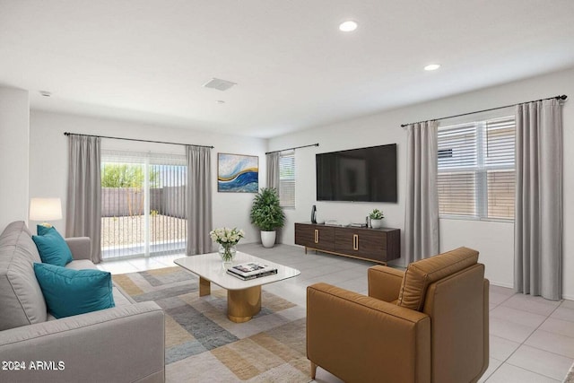 living area featuring light tile patterned floors, recessed lighting, and visible vents