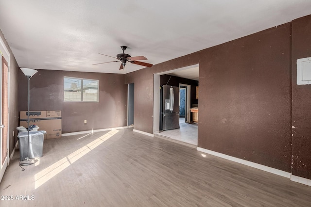 unfurnished room with wood-type flooring and ceiling fan