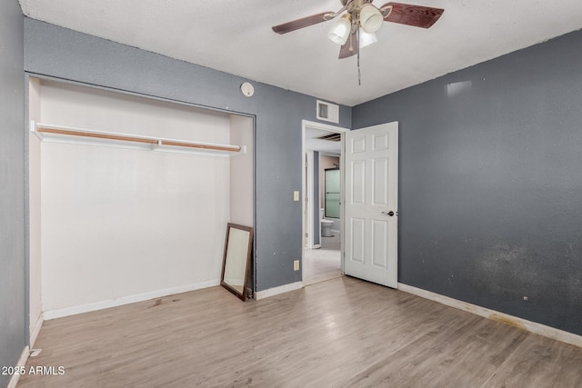 unfurnished bedroom featuring a closet, ceiling fan, and light hardwood / wood-style flooring