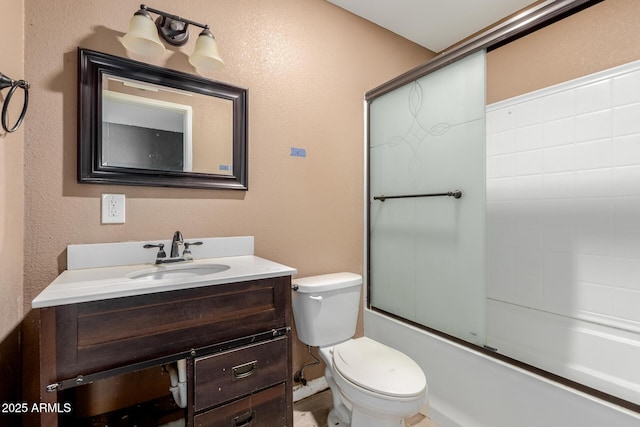 full bathroom featuring vanity, shower / bath combination with glass door, and toilet