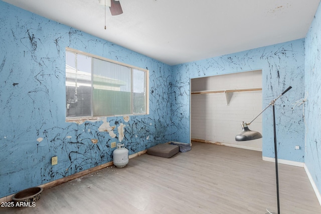 interior space featuring wood-type flooring and ceiling fan