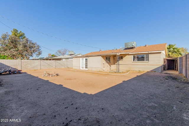 back of house with central AC and french doors