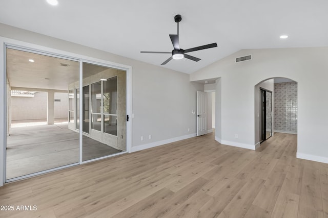 empty room featuring ceiling fan, light wood-type flooring, and lofted ceiling