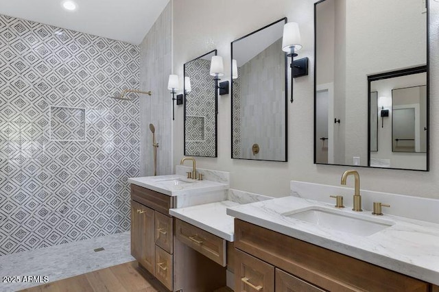 bathroom featuring vanity, hardwood / wood-style flooring, and walk in shower