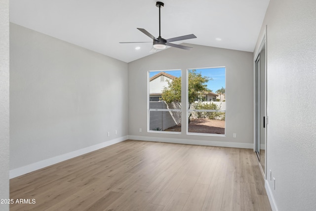 unfurnished room with ceiling fan, lofted ceiling, and light wood-type flooring