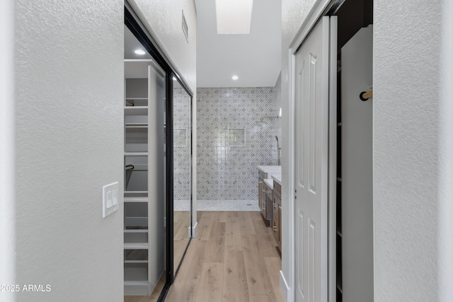 bathroom with a shower, vanity, and hardwood / wood-style flooring