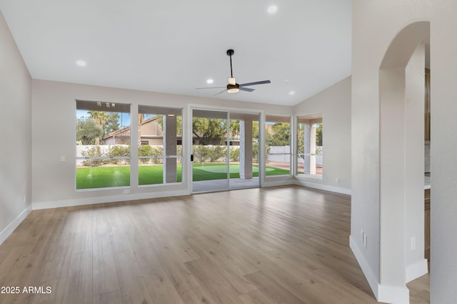 unfurnished room featuring ceiling fan, light hardwood / wood-style flooring, and lofted ceiling