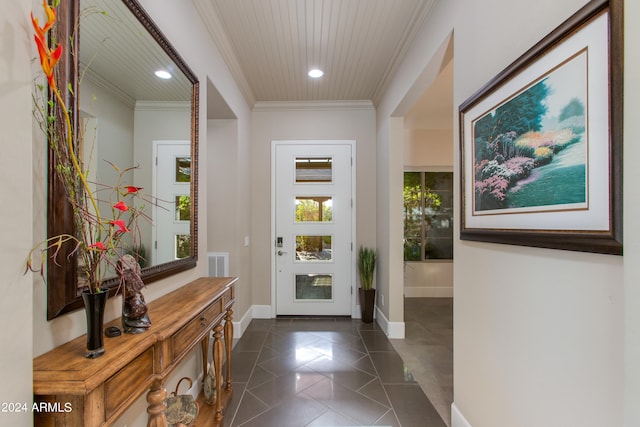 doorway to outside featuring ornamental molding and dark tile patterned floors