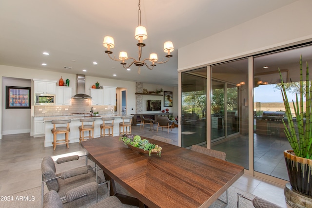 tiled dining room with a chandelier