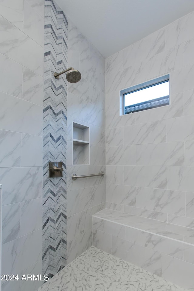 bathroom with tiled shower