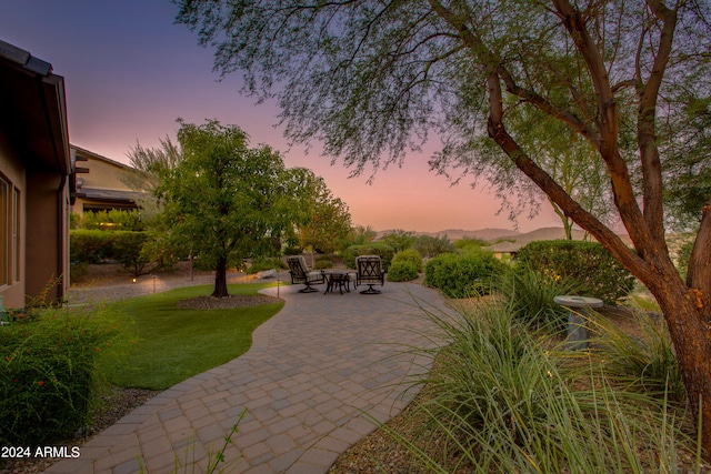 patio terrace at dusk with a lawn