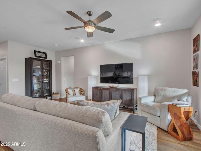 living room featuring ceiling fan and light wood-type flooring