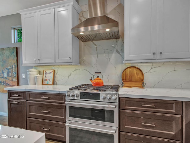 kitchen with decorative backsplash, dark brown cabinets, range with two ovens, and island exhaust hood