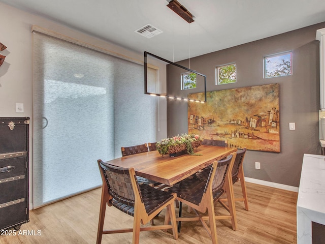 dining space featuring light wood-type flooring