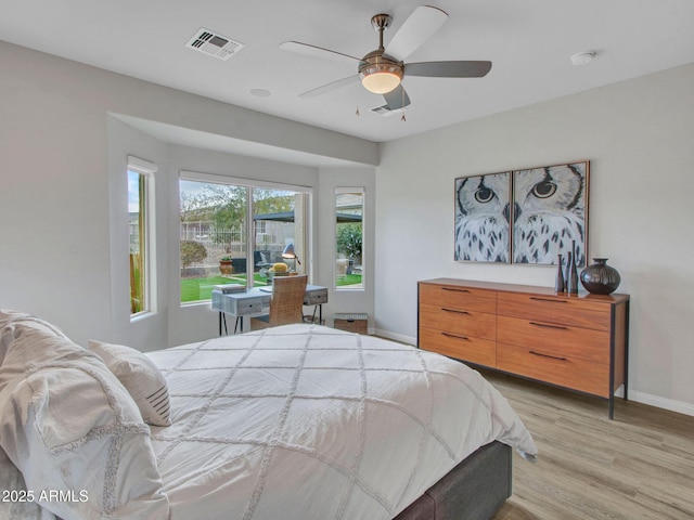 bedroom with light hardwood / wood-style flooring and ceiling fan