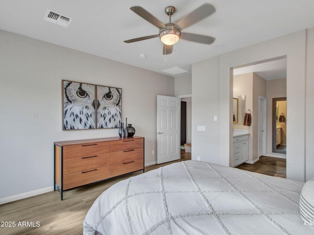 bedroom featuring light wood-type flooring, connected bathroom, and ceiling fan