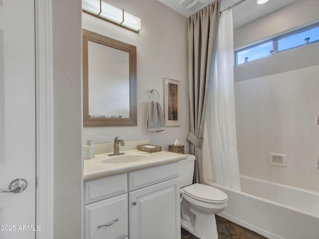 full bathroom with shower / tub combo with curtain, vanity, and toilet