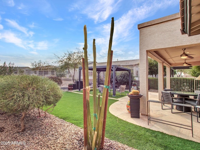 view of yard with a gazebo, ceiling fan, and a patio area