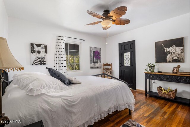 bedroom featuring ceiling fan, wood finished floors, and baseboards