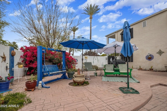 view of patio featuring fence