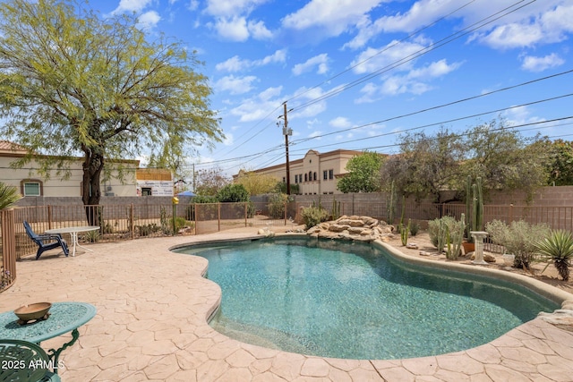 view of swimming pool featuring a patio, a fenced in pool, and a fenced backyard