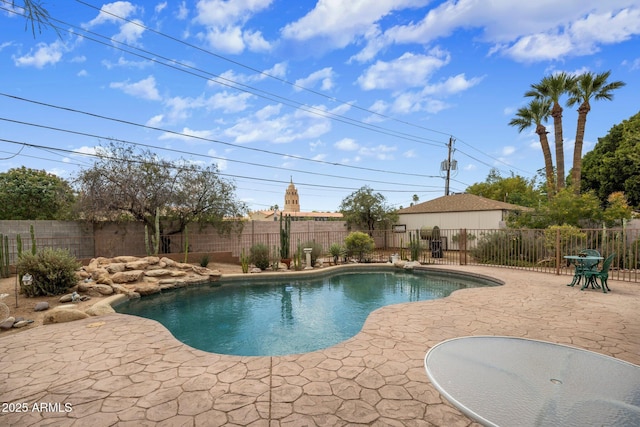 view of pool featuring a patio, a fenced backyard, and a fenced in pool