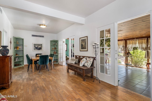 dining area featuring wood finished floors, visible vents, and french doors