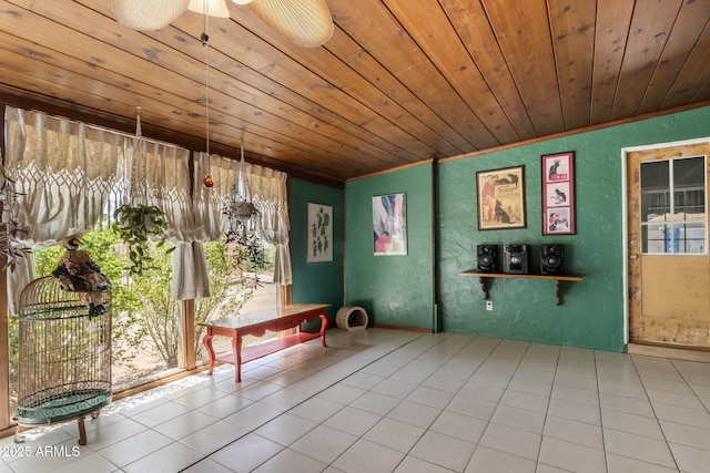 unfurnished dining area with a textured wall, ornamental molding, tile patterned flooring, and wooden ceiling