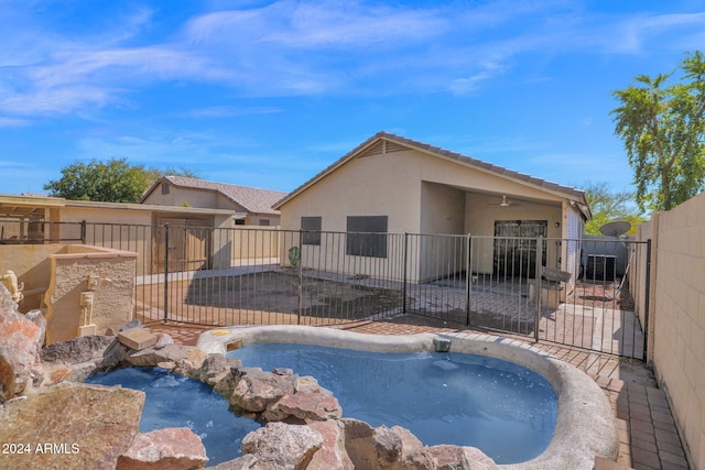 view of pool with a hot tub, a patio area, and cooling unit