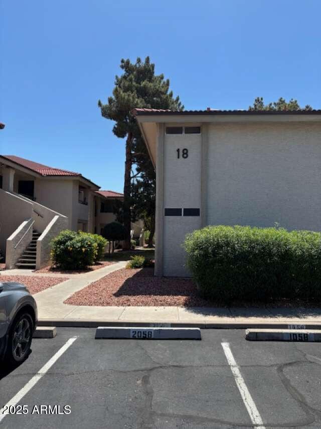 exterior space featuring uncovered parking and stucco siding