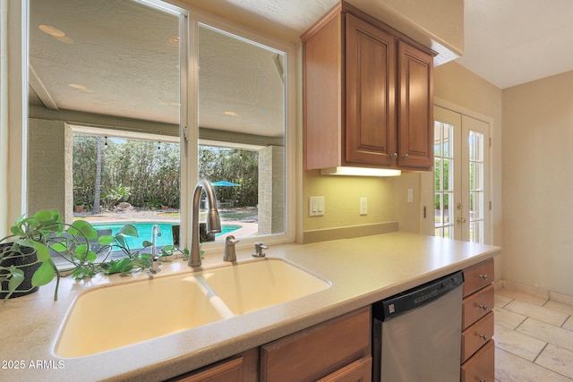 6911 E Thunderbird Rd, Scottsdale, AZ 85254 - kitchen with stainless steel dishwasher, plenty of natural light, and light countertops